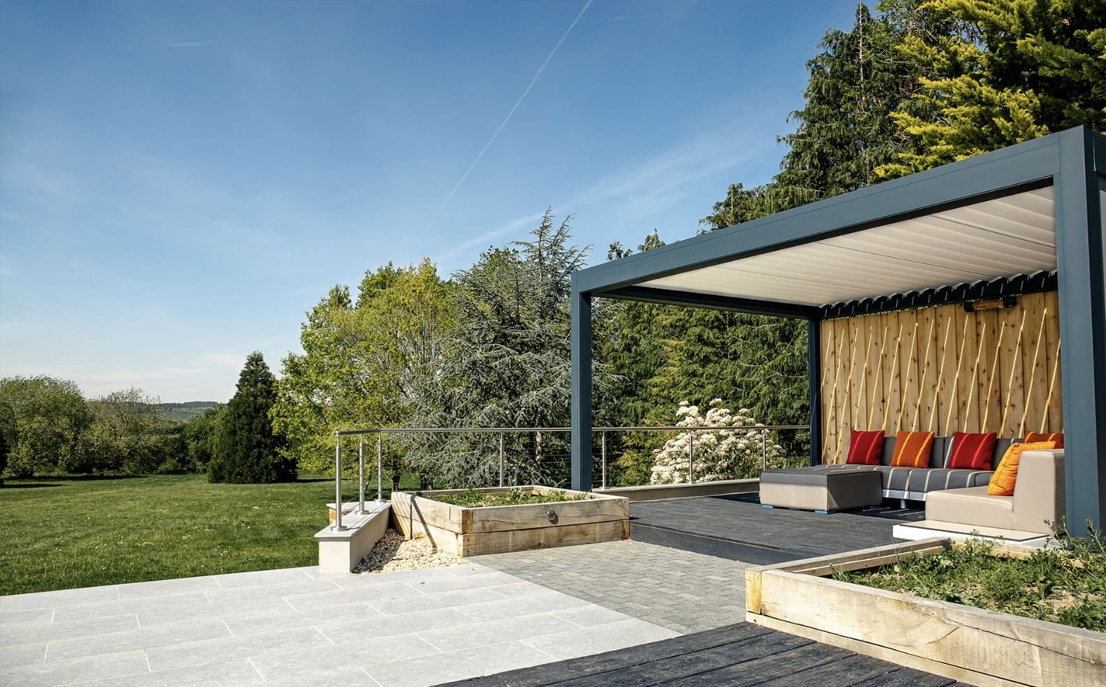 Louvred pergola with open roof and countryside garden views